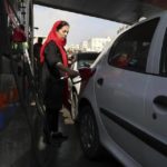 A woman fills her car at a gas station in Tehran, Iran, on Friday, November 15, 2019.