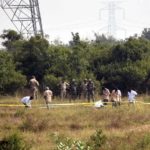 Police officers stand guard at the spot where accused in the rape and murder of the woman veterinarian were killed in an encounter, in Hyderabad on Friday.