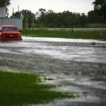 A single truck is parked in an open lot as heavy rains from hurricane Laura fall in Lake Charles.