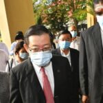 Malaysian former Finance Minister and Penang Chief Minister Lim Guan Eng, center, arrives at courthouse in Butterworth, Malaysia, Monday, Aug. 10, 2020
