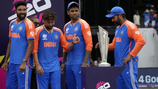 India's captain Rohit Sharma and teammates Suryakumar Yadav, Kuldeep Yadav and Mohd Siraj stand next to the winners' trophy after winning against South Africa in the ICC Men's T20 World Cup final cricket match at Kensington Oval in Bridgetown, Barbados, Saturday.
